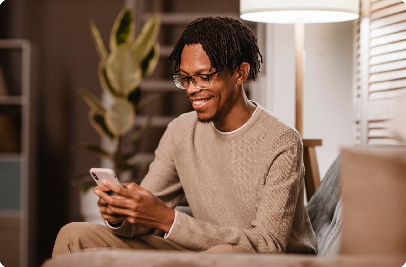 man using modern smarphone device while at coach at home
